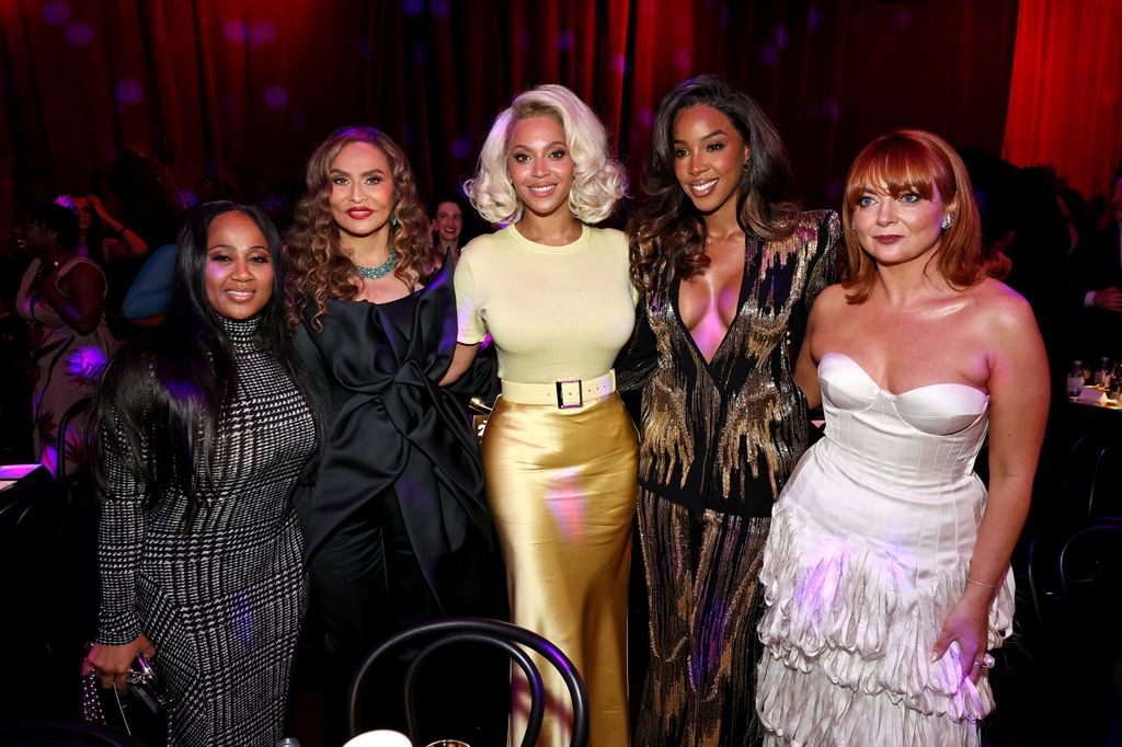 Tina Knowles, Beyonce, Kelly Rowland and Samantha Barry pose in dark room