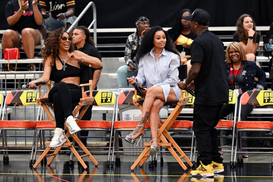 Blac Chyna and Tamar Braxton sit in chairs while talking to Ray J