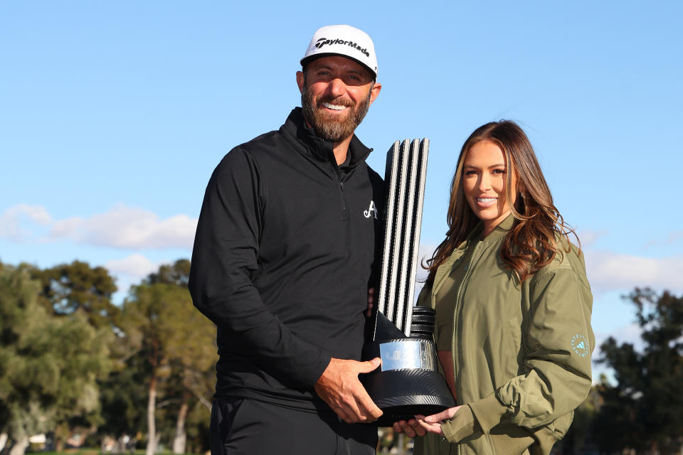 LAS VEGAS, NEVADA - FEBRUARY 10: Captain Dustin Johnson of 4Aces GC poses with his wife Paulina Gretzky and the individual trophy after winning during day three of the LIV Golf Invitational - Las Vegas at Las Vegas Country Club on February 10, 2024 in Las Vegas, Nevada. (Photo by Michael Reaves/Getty Images)