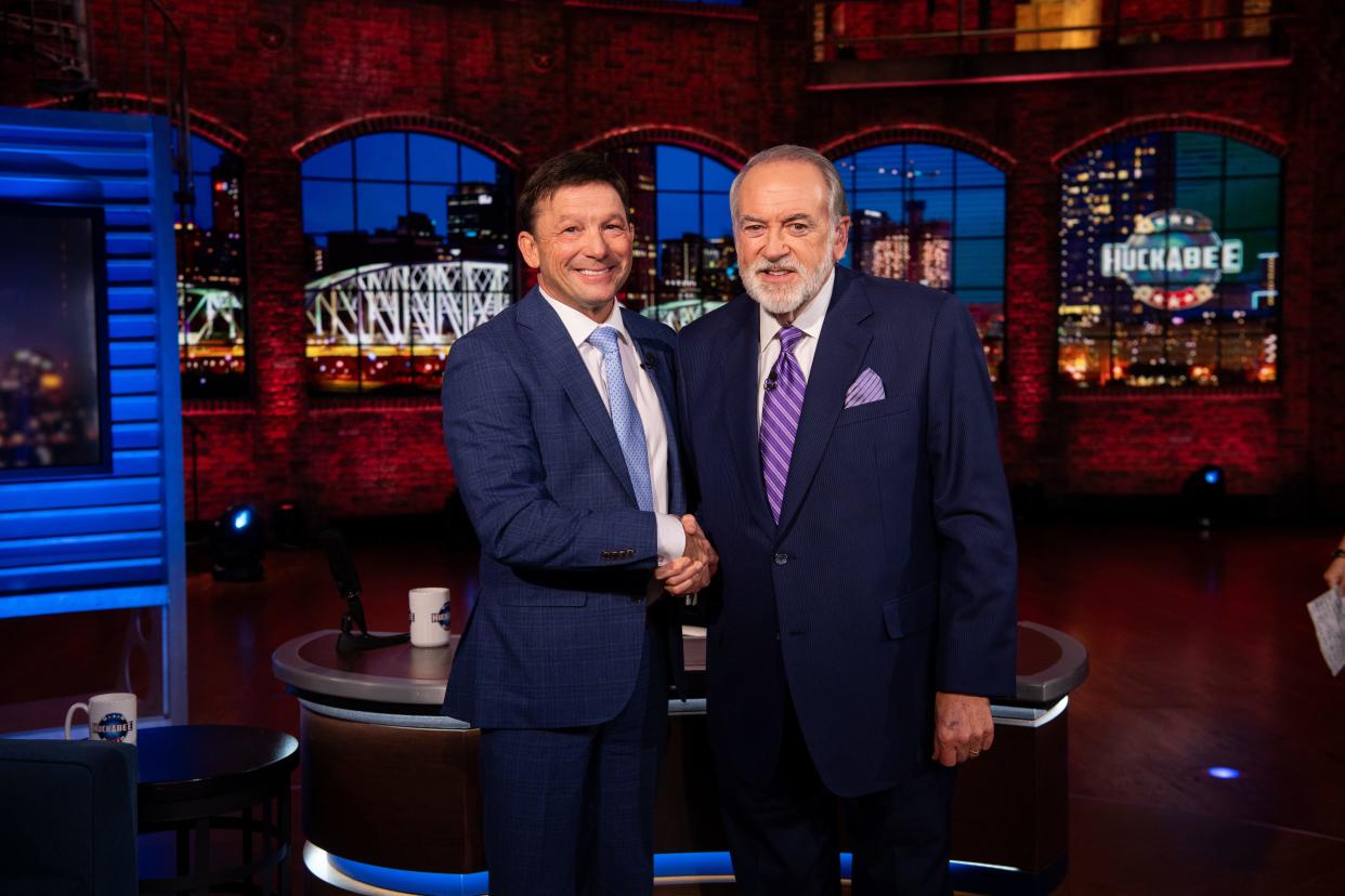 Attorney Scott Poynter, left, and former Arkansas Governor Mike Huckabee after taping the October 12 episode of the Trinity Broadcasting Network talk show, "Huckabee."