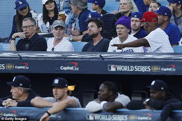 Actor Billy Crudup (second left), Jason Bateman and musician Flea watch Game 1