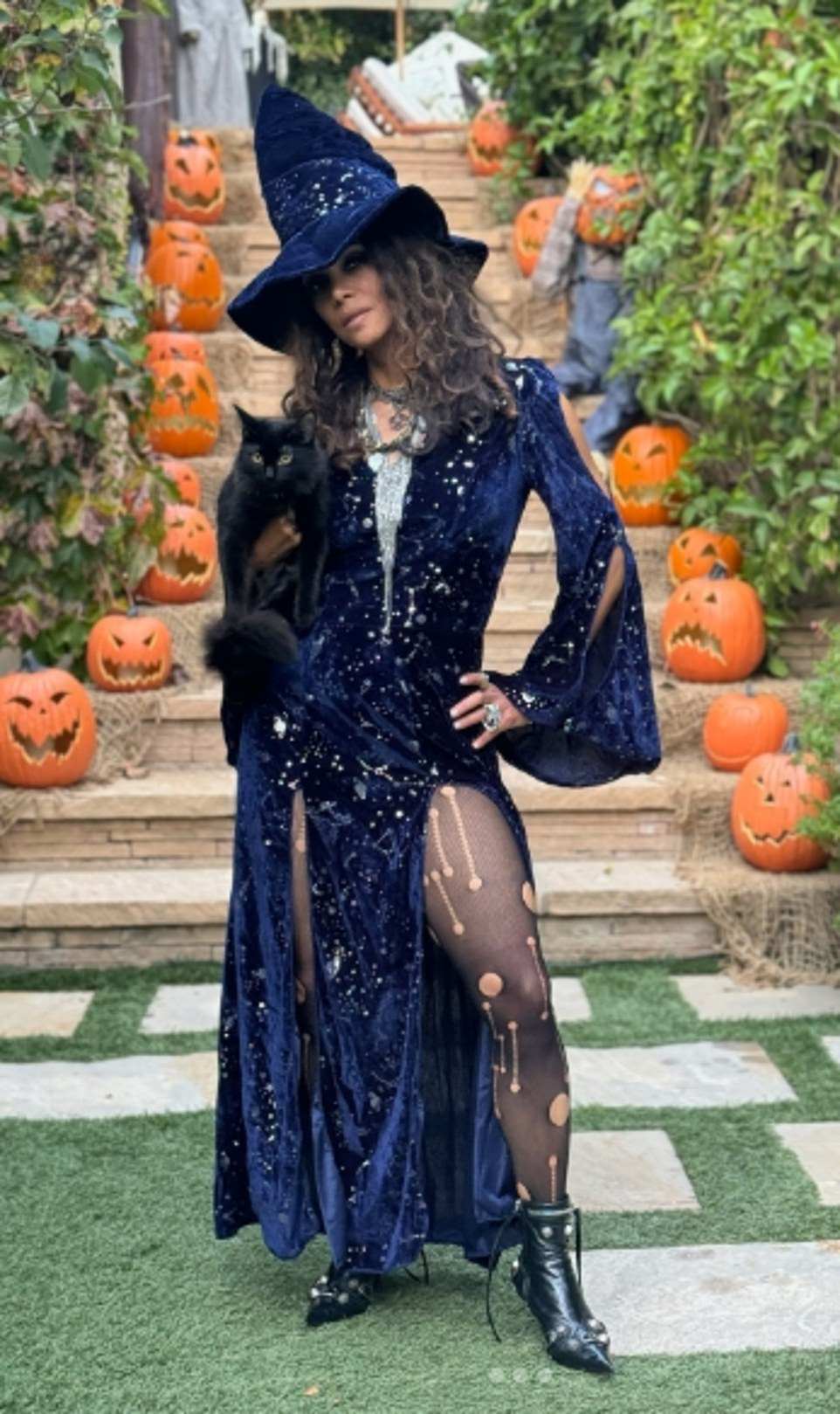 Meanwhile Berry embraced the spooky vibe, and looked sensational as she put on a very leggy display in a midnight blue witches dress in snaps shared to Instagram