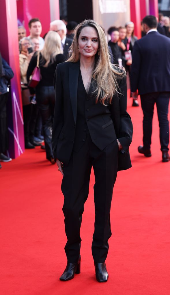 Angelina Jolie on red carpet in black trousers and blazer