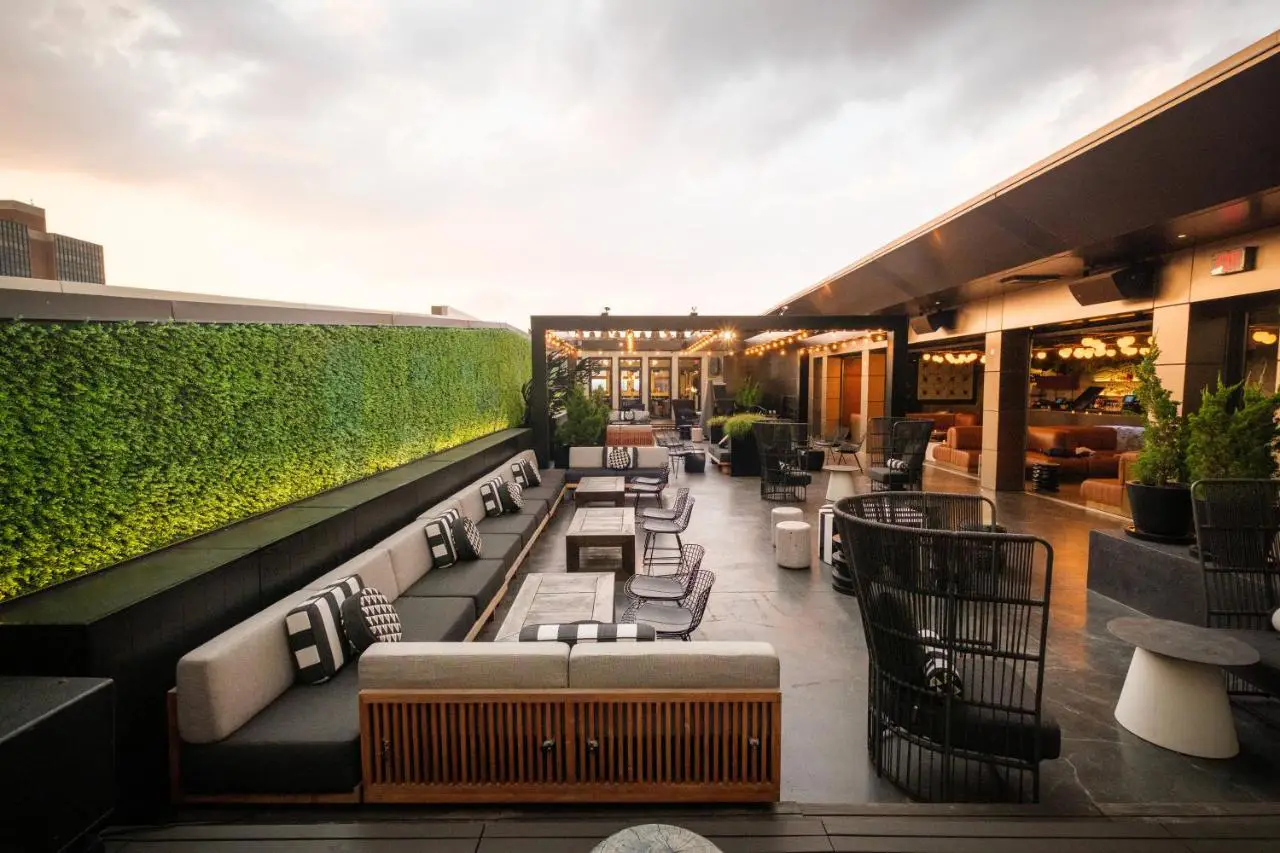 The chic Stratus Rooftop Lounge at Kimpton Hotel Monaco Philadelphia, offering modern seating and a vibrant atmosphere.